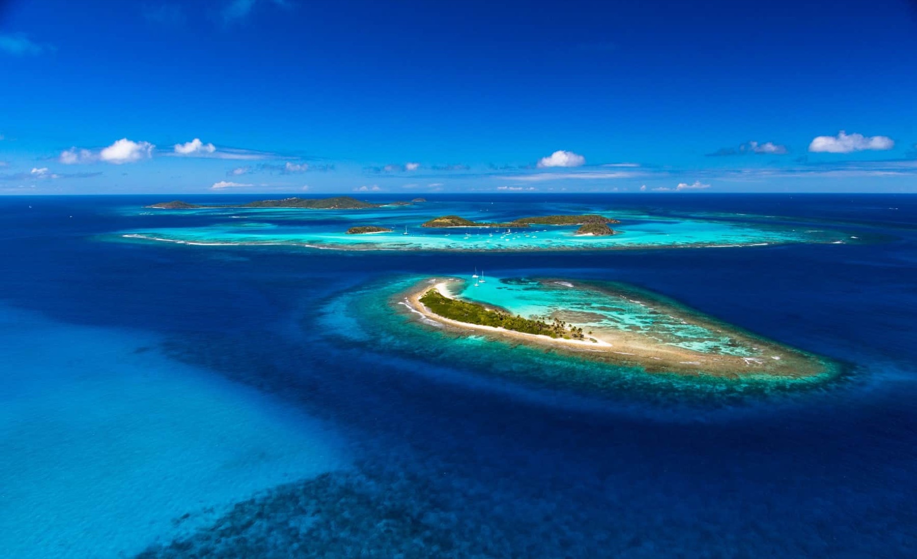 Wide drone view of the full Tobago Cays archipelago and reefs