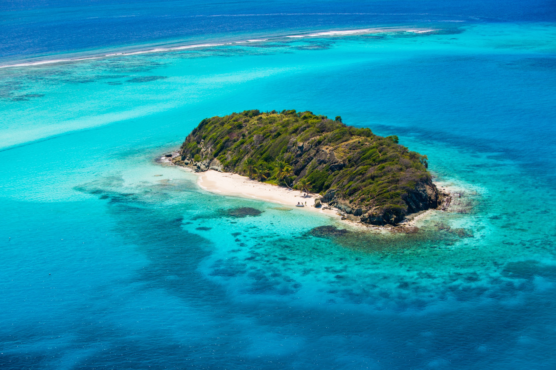 Aerial view of a Tobago Cays island surrounded by clear water